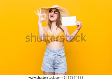 Young caucasian woman going to shopping Young caucasian woman ready to go to the beach with a placard