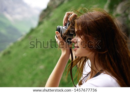 woman with camera nature summer mountains