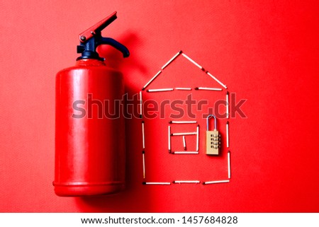 Fire safety, or security and protection concept. A fire extinguisher, the figure of the house and lock.
