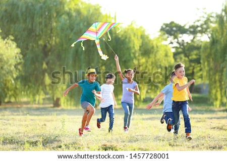 Children flying kite on summer day Royalty-Free Stock Photo #1457728001
