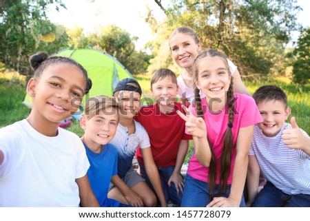 Group of children taking selfie at summer camp
