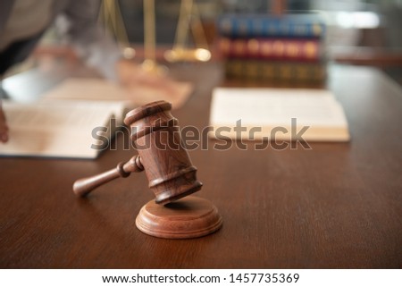 Judge gavel with law books and women lawyer in law firm. concept of legal ruling legislation.