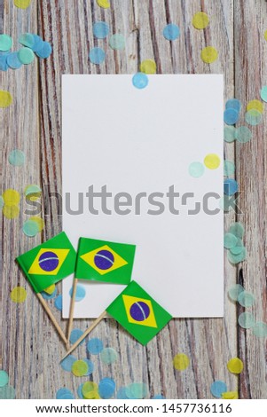 September 7. Independence day of Brazil, the concept of independence , patriotism and freedom. Mini paper flags with confetti and white postcard on wooden background