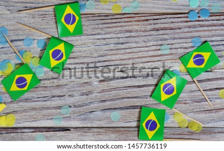 September 7. Brazil independence day concept of independence , patriotism and freedom. Mini paper flags with confetti on wooden background. horizontal