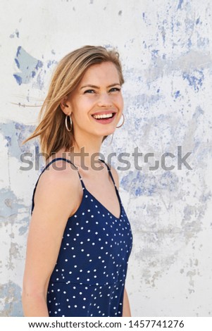 Happy blond woman in blue dress, portrait Royalty-Free Stock Photo #1457741276
