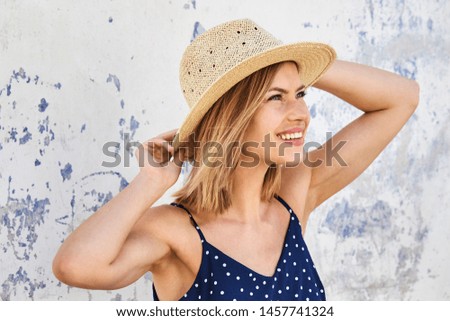 Beautiful blond in straw hat, looking up