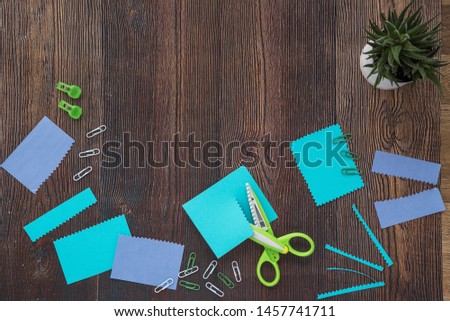 Craft accessories and potted plant on wooden table