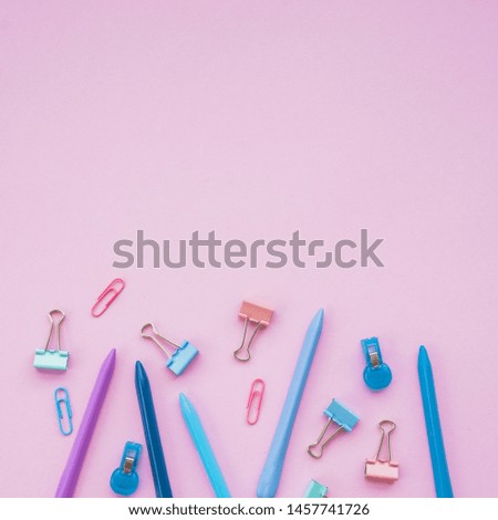 Various paper clips and crayon color on plain background