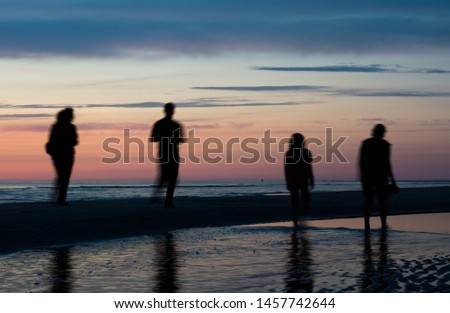 Family and friends enjoying sunset on the beach