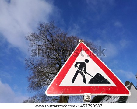 Old traffic sign in front of blue sky at a construction site on a sunny day in the city of Oerlinghausen in East Westphalia in Germany