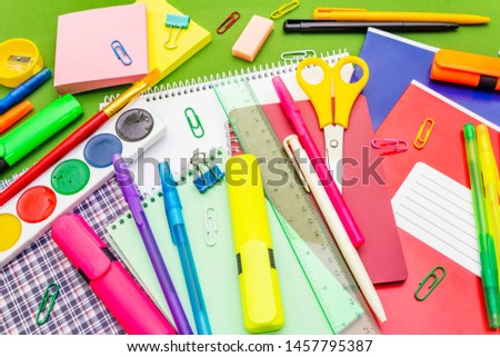 Back to school concept. School education supplies on bright green background, flat lay, close up