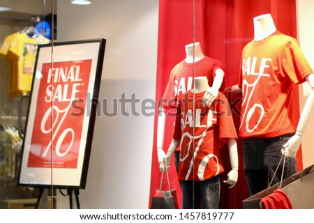 Mannequins in a shop window. Shopping sale background. Store discount sign.