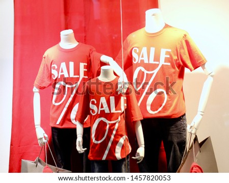 Mannequins in a shop window. Shopping sale background. Store discount sign.