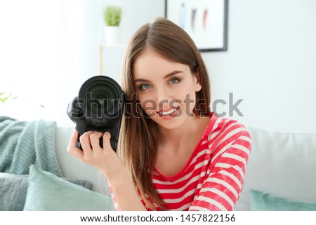 Young female photographer at home