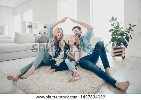 Photo of foster family with two children moving new apartments making arms roof promise protection forever Royalty-Free Stock Photo #1457834039