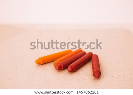 
Red wax crayons on the table