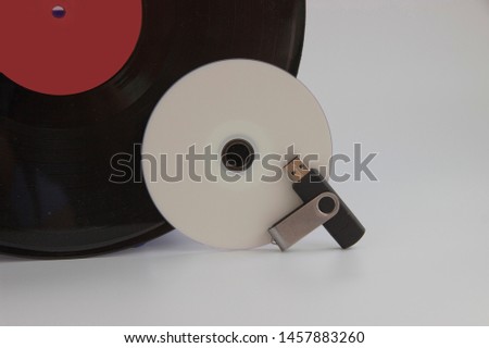 carriers of musical information of different years. vinyl, laser disc and flash drive