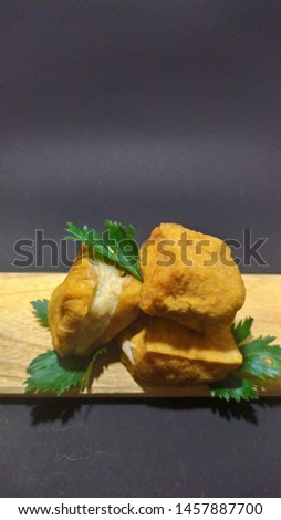 tofu meatballs on a wooden mat with a black background