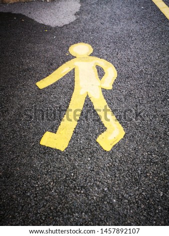 A symbol painted on the road to show pedestrian walkway