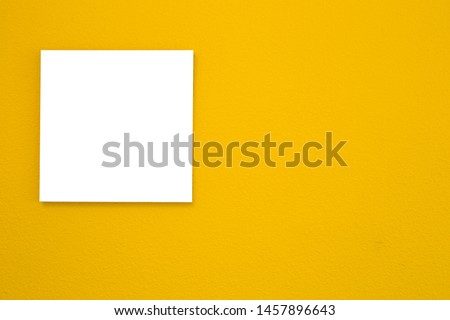 White canvas frame on yellow wall texture background. space for text, modern retro design close-up