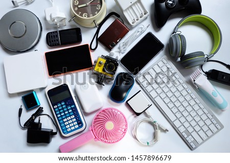 many used modern Electronic gadgets for daily use on White floor, Reuse and Recycle concept, Top view. Royalty-Free Stock Photo #1457896679