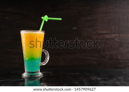 Cool summer drink yellow melon juice on dark background