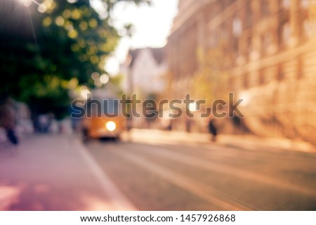 Background, blur, out of focus, bokeh. Soft sunlight, tram rides on the streets of the city.