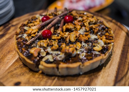 Picture of cashew nut and caramel syrup on chocolate tart cake