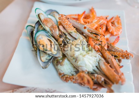 Picture of A delicious seafood at luxury restaurant. A plate of fresh seafood with shrimps, prawns, crabs, salmon, squid and mussels