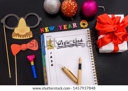 Wish list in notepad on the table