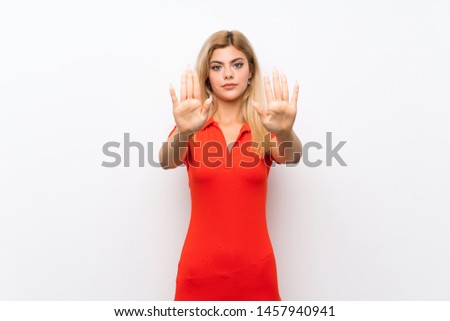 Teenager girl over isolated white background making stop gesture and disappointed