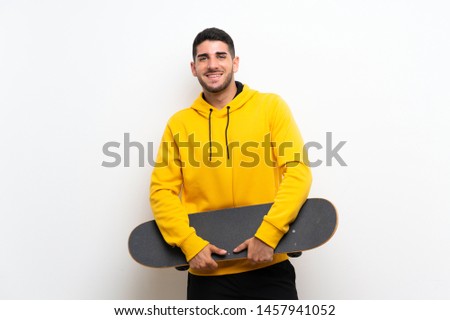 Handsome young skater man over isolated white wall