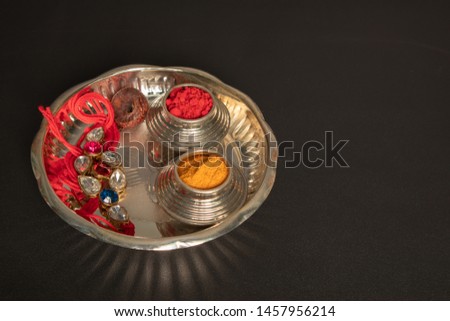 Raksha bandhan raakhi or rakhi with pooja plate a traditional Hindu festival or ceremony on black background,
