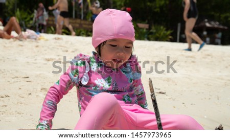Cute little asian girl play at the beach