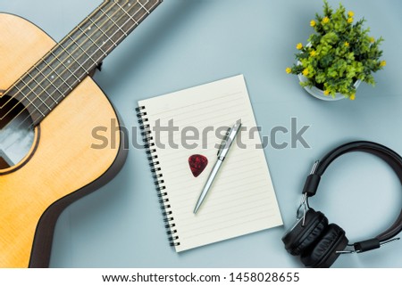 top view guitar and note book and headphone, music concept