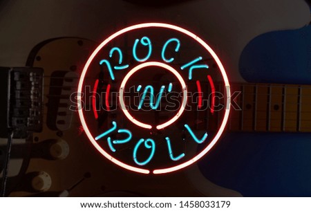 electric guitar with Rock n Roll neon sign