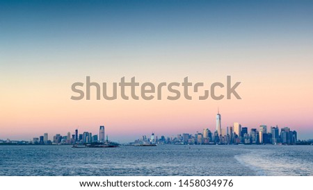 Scenic sunset at the financial district  in New York City and New Jersey, shot from the State Island Ferry