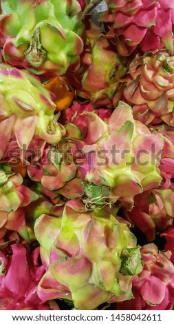 piles of dragon fruit sold on the market