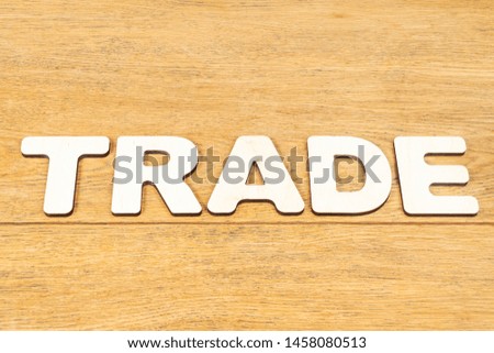 Word - trade, laid out in wooden letters on an old wooden table