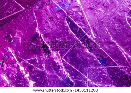 Background in the style of the 80-90s. Real texture of broken glass and drops in bright acid colors.