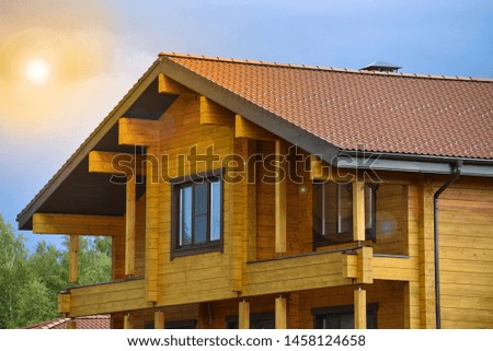 The facade of the wooden house in modern style. Natural photo.