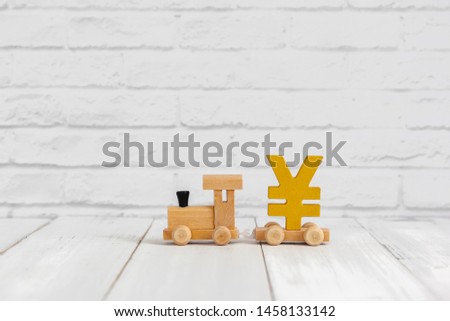 Golden yen sign on wood train over white background with copy space , money concept.