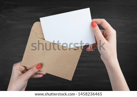 A woman holding a white business card