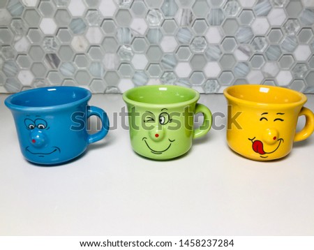 ceramic porcelain luxury coffee cups double and triple side by side in a row conceptual photo shot objects on white stone background background mosaic luxury kitchen utensils colorful white blue green