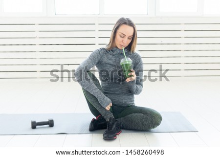 Healthy lifestyle, people and sport concept - Woman with healthy juice drinking for sport and fitness