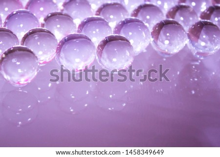 Gentle beautiful abstract purple background of gel balls. Macro of hydrogel round form. Pattern of polymer. Female girly or wedding wallpaper