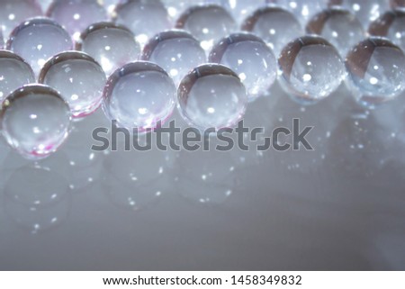 Gentle gray beautiful abstract background of gel balls. Macro of hydrogel round form. Pattern of polymer. Female girly or wedding wallpaper