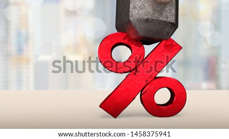 Sledgehammer smashing red percentage sign cracked on wooden table with blur background.