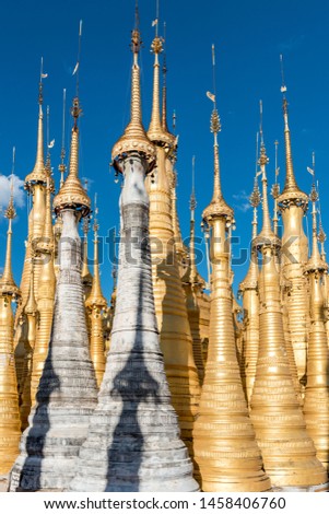 Vertical picture of impressive golden stupas at Indein Temple, landmark of Inle lake, Myanmar