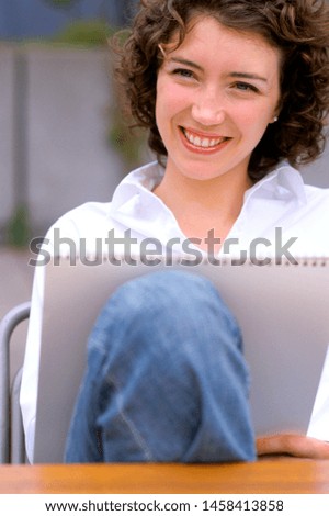 Woman sketching on artist pad.